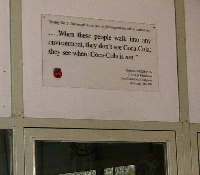 Coca-cola plaque being pretty honest about world domination